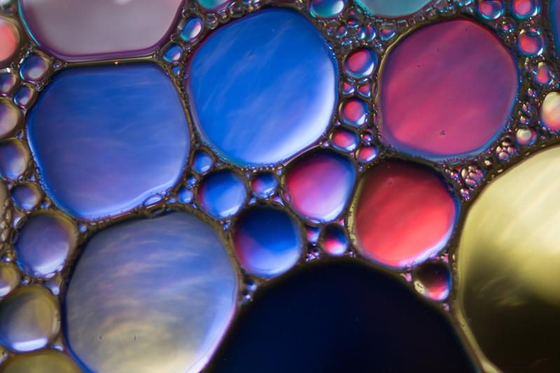 Incandescent oil bubbles floating on a water surface